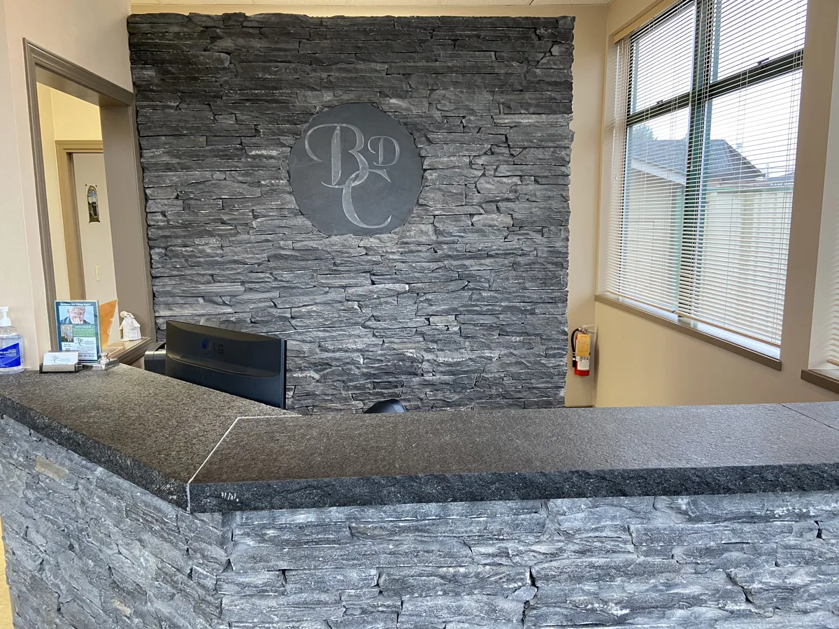 The slate front desk with the engraved BDC monogram on the wall