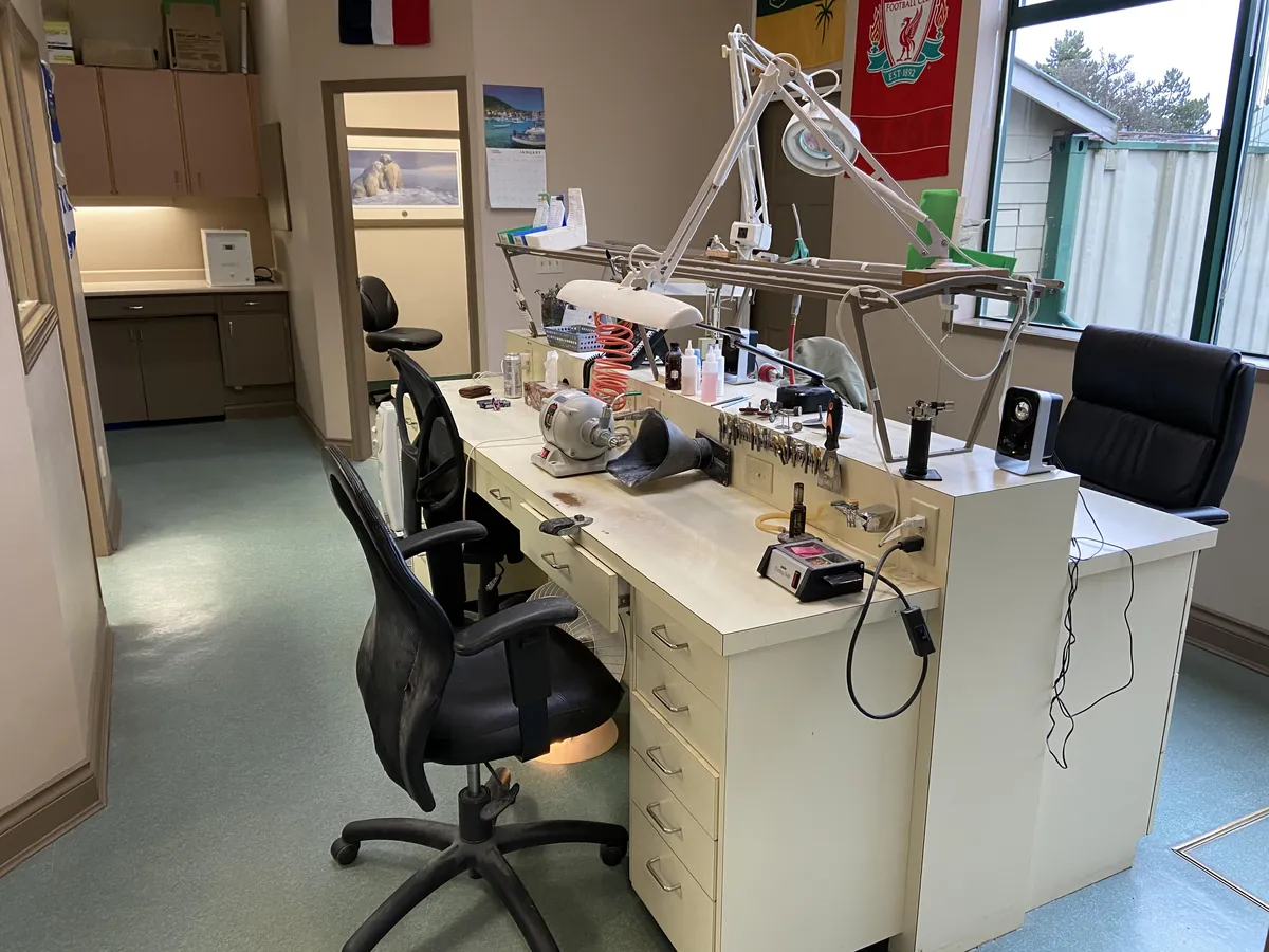 The lab bench at Burnside Denture Clinic, with lamp, lathe and tools