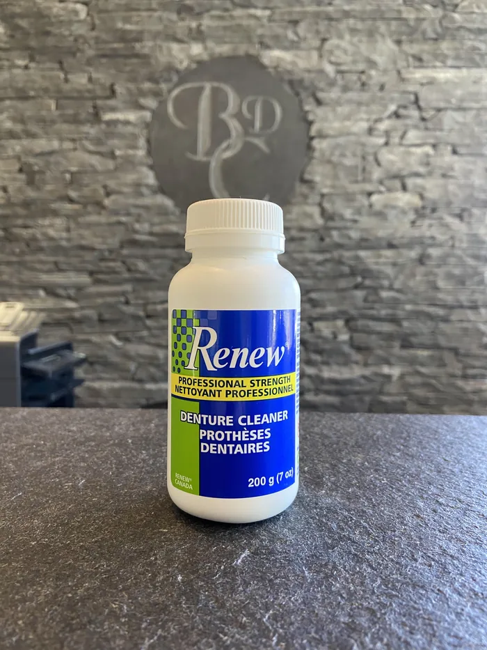 A tub of Renew professional strength denture cleaner on the slate counter at the clinic